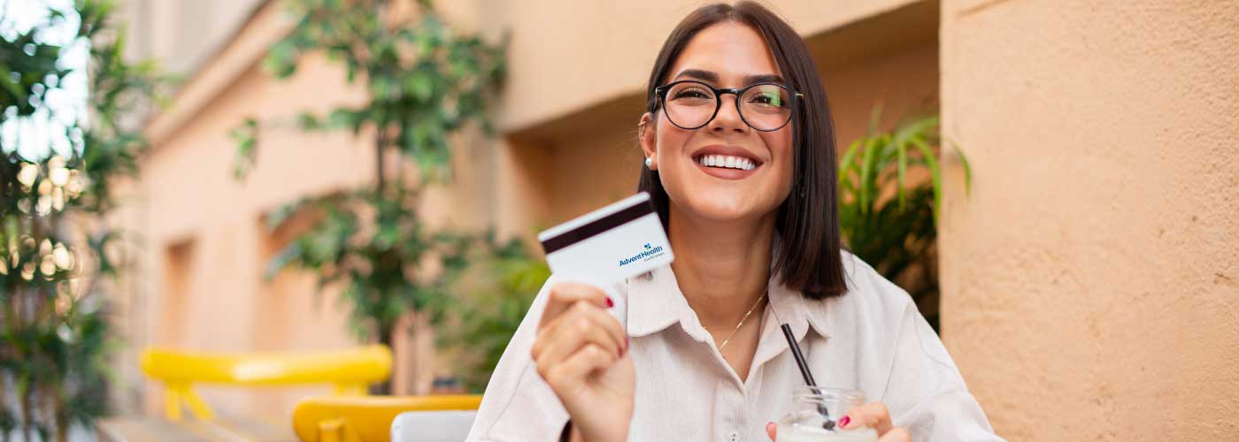 Woman smiling holding a credit card